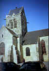 RED BUTTONS DANGLES FROM CHURCH AT ST. MERE EGLISE.jpg (99390 bytes)